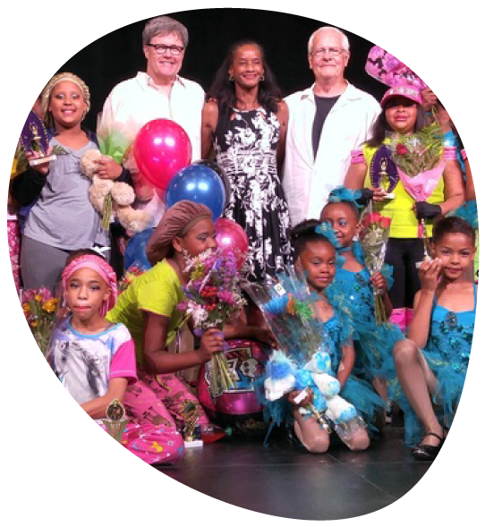 Rex standing with members of a dance club after a performance.